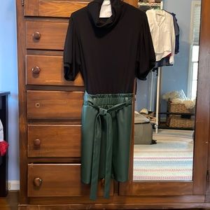 Drew dress with black mock turtleneck and vegan leather skirt in dark green.